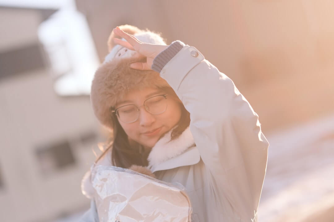 A calm, confident person standing in warm afternoon light, looking grounded and self-assured